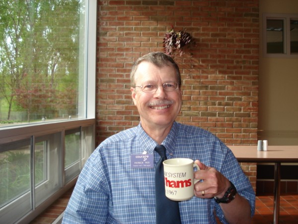 Pat guzzling coffee in Courage Center''s cafeteria, Handiham mug in hand